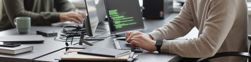 man at sitting at a desk on a computer