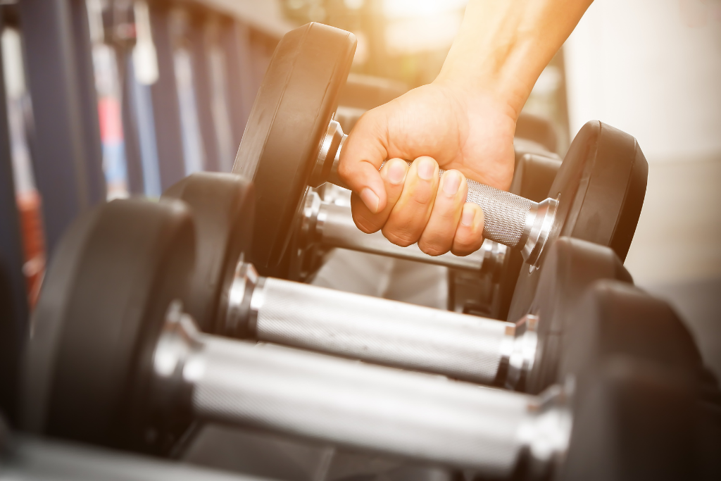 a hand lifting weights at a gym