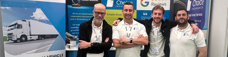 4 people standing at an exhibition stand